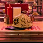 SATOSHI NAKAMOTO STUDDED WRAP AROUND LEATHER CAP